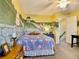 Bedroom with custom whimsical mural and a comfortable bed at 1093 Spruce Creek Ln, Lawrenceville, GA 30045