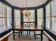Charming dining room area featuring natural light, plantation shutters, and a chandelier at 1093 Spruce Creek Ln, Lawrenceville, GA 30045
