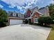 Lovely brick home featuring an attached two-car garage and well maintained landscaping at 1093 Spruce Creek Ln, Lawrenceville, GA 30045