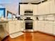 Kitchen featuring white cabinets, stainless steel appliances and hardwood floors at 1093 Spruce Creek Ln, Lawrenceville, GA 30045