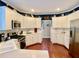 Well-lit kitchen with white cabinetry, stainless steel appliances, and hardwood flooring at 1093 Spruce Creek Ln, Lawrenceville, GA 30045