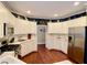 Bright, updated kitchen featuring white cabinets, stainless steel appliances, and hardwood floors at 1093 Spruce Creek Ln, Lawrenceville, GA 30045