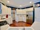 Bright kitchen featuring white cabinetry, stainless steel appliances, and hardwood floors at 1093 Spruce Creek Ln, Lawrenceville, GA 30045