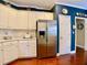 Bright kitchen featuring white cabinets and stainless steel refrigerator at 1093 Spruce Creek Ln, Lawrenceville, GA 30045