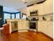 Kitchen featuring white cabinets, stainless steel appliances and hardwood floors at 1093 Spruce Creek Ln, Lawrenceville, GA 30045