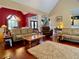 Open-concept living room and dining room with hardwood floors and neutral decor at 1093 Spruce Creek Ln, Lawrenceville, GA 30045