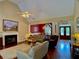 Bright living room with a fireplace, wood floors, and a view into the adjacent dining area at 1093 Spruce Creek Ln, Lawrenceville, GA 30045