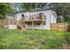 Backyard view features a two-story home with a private deck, stairs, and lush green lawn at 176 Rhodesia Se Ave, Atlanta, GA 30315