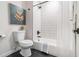 Modern bathroom featuring a tub with white subway tile surround and black hardware at 176 Rhodesia Se Ave, Atlanta, GA 30315