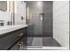 Sleek modern bathroom features black and white tiling, glass shower, and stylish vanity at 176 Rhodesia Se Ave, Atlanta, GA 30315