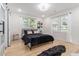 Bright bedroom featuring hardwood floors, multiple windows and stylish contemporary decor at 176 Rhodesia Se Ave, Atlanta, GA 30315
