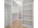 Walk-in closet featuring custom shelving and hardwood floors at 176 Rhodesia Se Ave, Atlanta, GA 30315