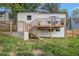 Exterior view shows a two-story home with a private deck, stairs, and a well-maintained yard at 176 Rhodesia Se Ave, Atlanta, GA 30315