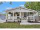 Charming bungalow featuring a welcoming front porch with hanging plants and stylish landscaping at 176 Rhodesia Se Ave, Atlanta, GA 30315