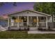 Charming bungalow featuring a welcoming front porch with hanging plants and stylish landscaping at 176 Rhodesia Se Ave, Atlanta, GA 30315