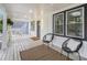 Spacious front porch with stylish seating, decorative rug, and recessed lighting overhead at 176 Rhodesia Se Ave, Atlanta, GA 30315