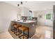 Charming kitchen with an island, breakfast bar, modern appliances, and hardwood floors at 176 Rhodesia Se Ave, Atlanta, GA 30315
