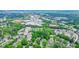 Aerial view showcases the homes, businesses and dense green trees at 3689 Spring Hill Se Rd, Smyrna, GA 30080