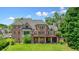 Beautiful brick home featuring a large deck, walk out basement, and lush green lawn at 3689 Spring Hill Se Rd, Smyrna, GA 30080