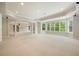Finished basement space with neutral carpet, recessed lighting, and large windows for natural light at 3689 Spring Hill Se Rd, Smyrna, GA 30080