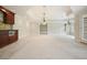 Basement area featuring neutral carpet, tray ceiling, lighting, and partial wet bar at 3689 Spring Hill Se Rd, Smyrna, GA 30080