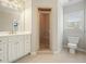 Well-lit bathroom with a glass door shower and a white vanity with ample storage space at 3689 Spring Hill Se Rd, Smyrna, GA 30080