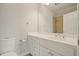 Bathroom features a white vanity with a single sink, mirror, and a shower with tile surround at 3689 Spring Hill Se Rd, Smyrna, GA 30080