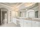Luxury bathroom with dual sinks and decorative cabinetry and large mirror at 3689 Spring Hill Se Rd, Smyrna, GA 30080