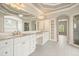 Luxurious bathroom with and sinks, lots of cabinetry, and decorative mirror at 3689 Spring Hill Se Rd, Smyrna, GA 30080