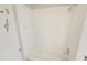 Bathroom shower features all-white tile, bathtub and a shower head at 3689 Spring Hill Se Rd, Smyrna, GA 30080