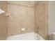 Shower/bath combo featuring neutral tile, sleek fixtures, and easy to clean surfaces at 3689 Spring Hill Se Rd, Smyrna, GA 30080