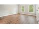 Bright bedroom featuring beautiful hardwood floors and two large windows overlooking the yard at 3689 Spring Hill Se Rd, Smyrna, GA 30080