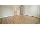 Neutral bedroom features wood floors, white trim, and an ensuite bathroom through a doorway at 3689 Spring Hill Se Rd, Smyrna, GA 30080