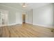 Spacious bedroom featuring hardwood floors, neutral walls, and multiple doorways for easy access at 3689 Spring Hill Se Rd, Smyrna, GA 30080