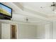 Bedroom with carpet, ceiling fan, and wall-mounted TV above a mirrored wall at 3689 Spring Hill Se Rd, Smyrna, GA 30080