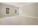 Large bedroom with carpet, ceiling fan, and two windows providing natural light at 3689 Spring Hill Se Rd, Smyrna, GA 30080