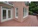 Wide angle photo of a deck, showcasing views of the brick house and trees at 3689 Spring Hill Se Rd, Smyrna, GA 30080