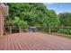 Wooden deck with a dark brown stain, featuring dark wood railings and a view of lush greenery at 3689 Spring Hill Se Rd, Smyrna, GA 30080
