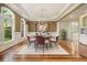 Formal dining room featuring hardwood floors, a stylish chandelier, and ample natural light at 3689 Spring Hill Se Rd, Smyrna, GA 30080