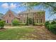Stately brick home with manicured front lawn, covered balcony and prominent entrance at 3689 Spring Hill Se Rd, Smyrna, GA 30080