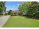 Large brick home with lush green lawn and mature trees at 3689 Spring Hill Se Rd, Smyrna, GA 30080