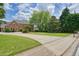 A large house features a brick exterior, a sprawling lawn, and a long driveway at 3689 Spring Hill Se Rd, Smyrna, GA 30080