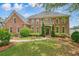 Beautiful brick home with a manicured lawn, decorative trees, and a covered entryway at 3689 Spring Hill Se Rd, Smyrna, GA 30080