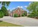 Elegant brick home with a three car garage and a circular driveway at 3689 Spring Hill Se Rd, Smyrna, GA 30080