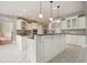 Bright kitchen boasts a large island, white cabinetry, granite countertops, and stainless appliances at 3689 Spring Hill Se Rd, Smyrna, GA 30080