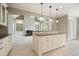 Kitchen island overlooking living room provides seating and complements adjacent stainless appliances at 3689 Spring Hill Se Rd, Smyrna, GA 30080