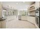 Eat-in kitchen with white cabinets, stainless steel appliances, and an adjacent breakfast area at 3689 Spring Hill Se Rd, Smyrna, GA 30080