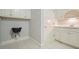 Functional laundry area with sleek black sink, white cabinets, and tiled floor for easy maintenance at 3689 Spring Hill Se Rd, Smyrna, GA 30080