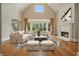 Bright living room with vaulted ceiling, fireplace, large windows, and hardwood floors at 3689 Spring Hill Se Rd, Smyrna, GA 30080