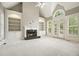 Bright living room featuring a fireplace, built-in bookshelves, and large windows with shutters at 3689 Spring Hill Se Rd, Smyrna, GA 30080
